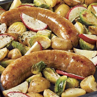 Our Recipes - Sausages, apples, and vegetables on a baking sheet | Marché Bonichoix