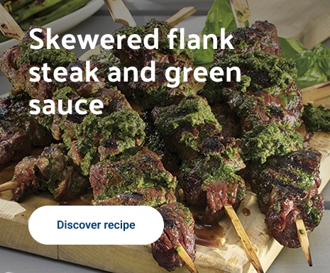 Skewered flank steak and green sauce
